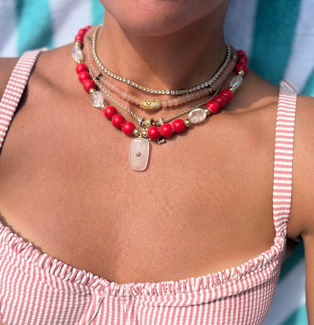 red beaded necklace with charm