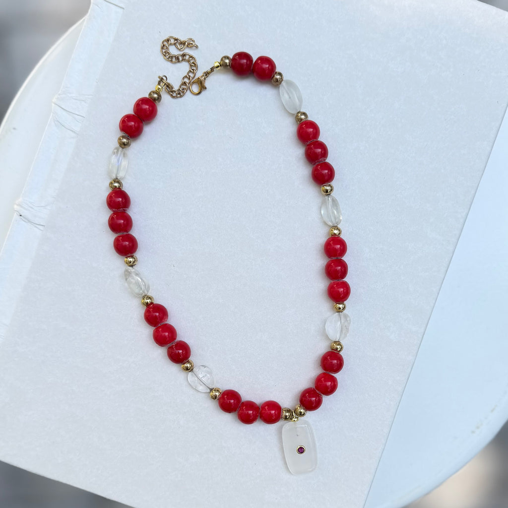 red beaded necklace with charm